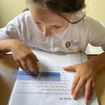 Student using tools to decode while reading.