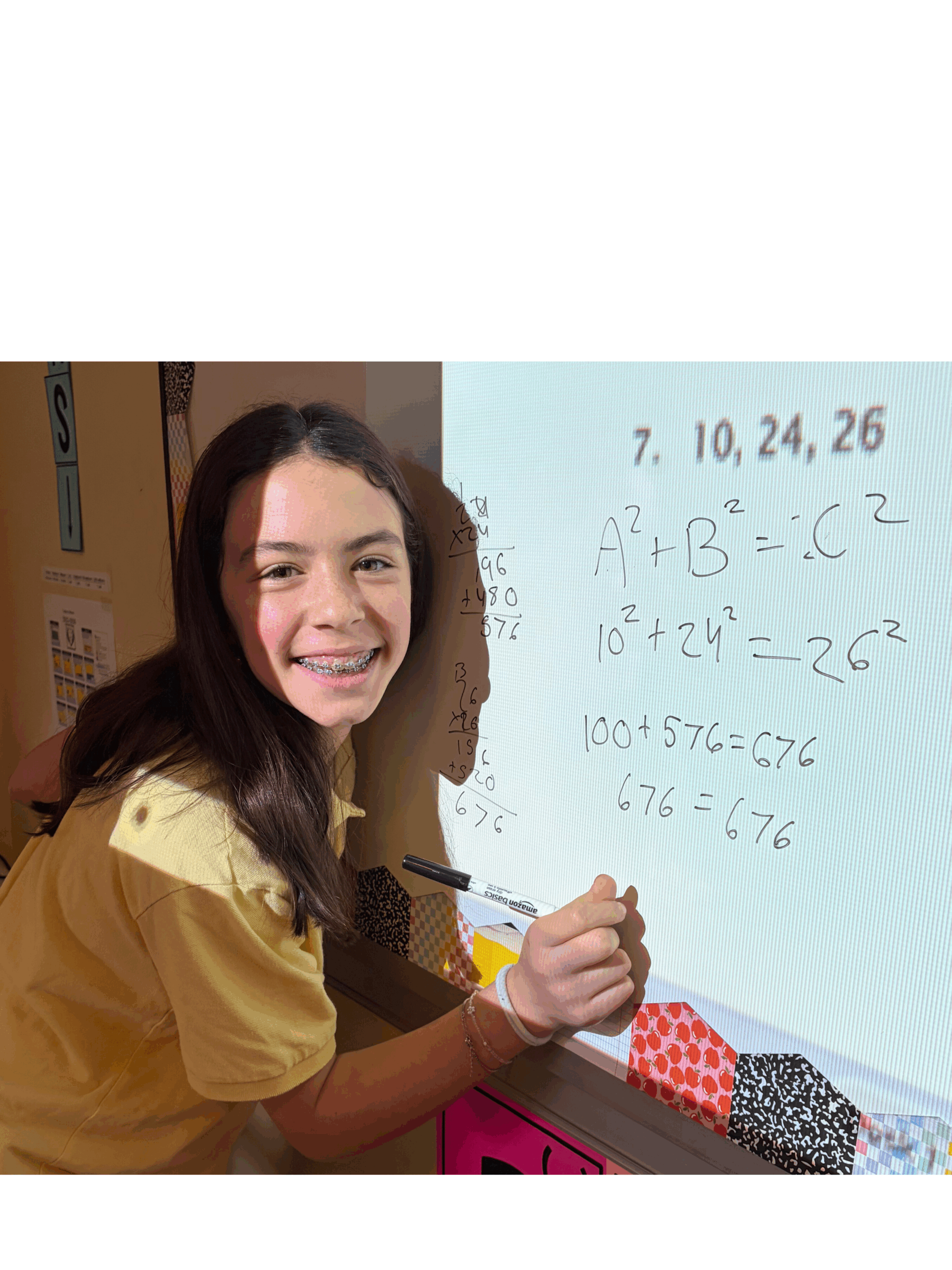 A middle school student at The Legacy School works a math problem on the whiteboard.