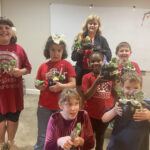 Students make chocolate lollipops and choose from a variety of succulents to create mini cauldrons to take home.