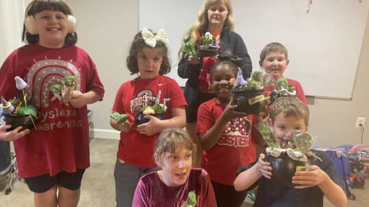 Students make chocolate lollipops and choose from a variety of succulents to create mini cauldrons to take home.