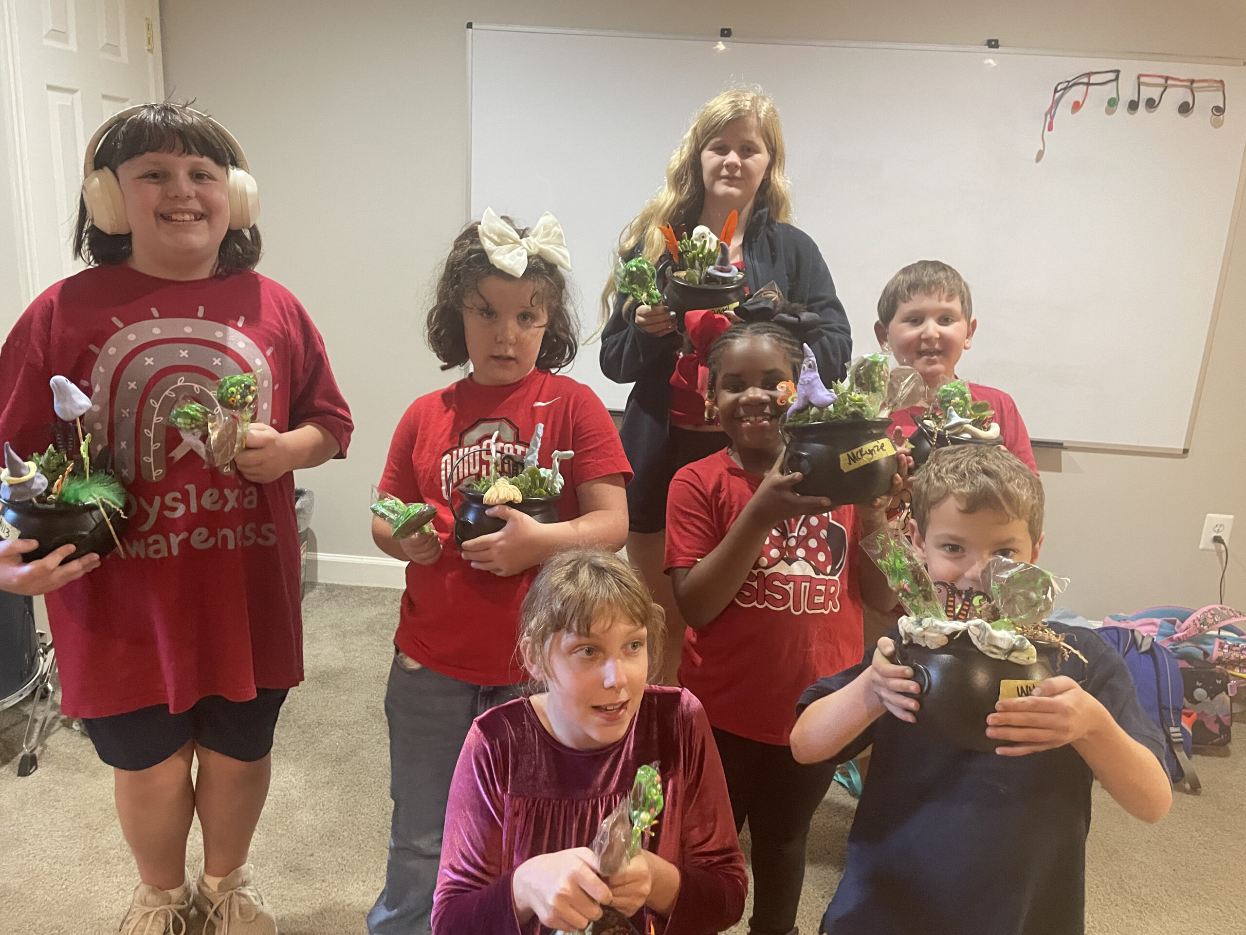 Students make chocolate lollipops and choose from a variety of succulents to create mini cauldrons to take home.
