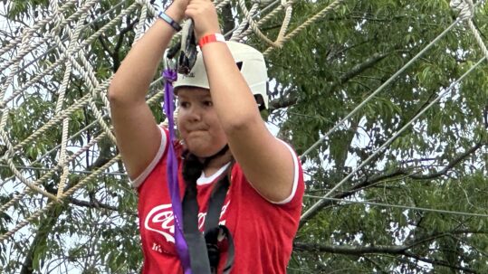 A student at The Legacy School plays on the ropes course at Kids After Hours at Red Barn Ranch