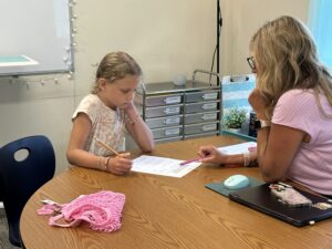 Student at Camp Terrapin at The Legacy School works one-on-one with tutor