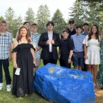 The Legacy School's Class of 2025 8th Graders stand with Founder and Head of School Jamie Caplan on 8th Grade Graduation Day!