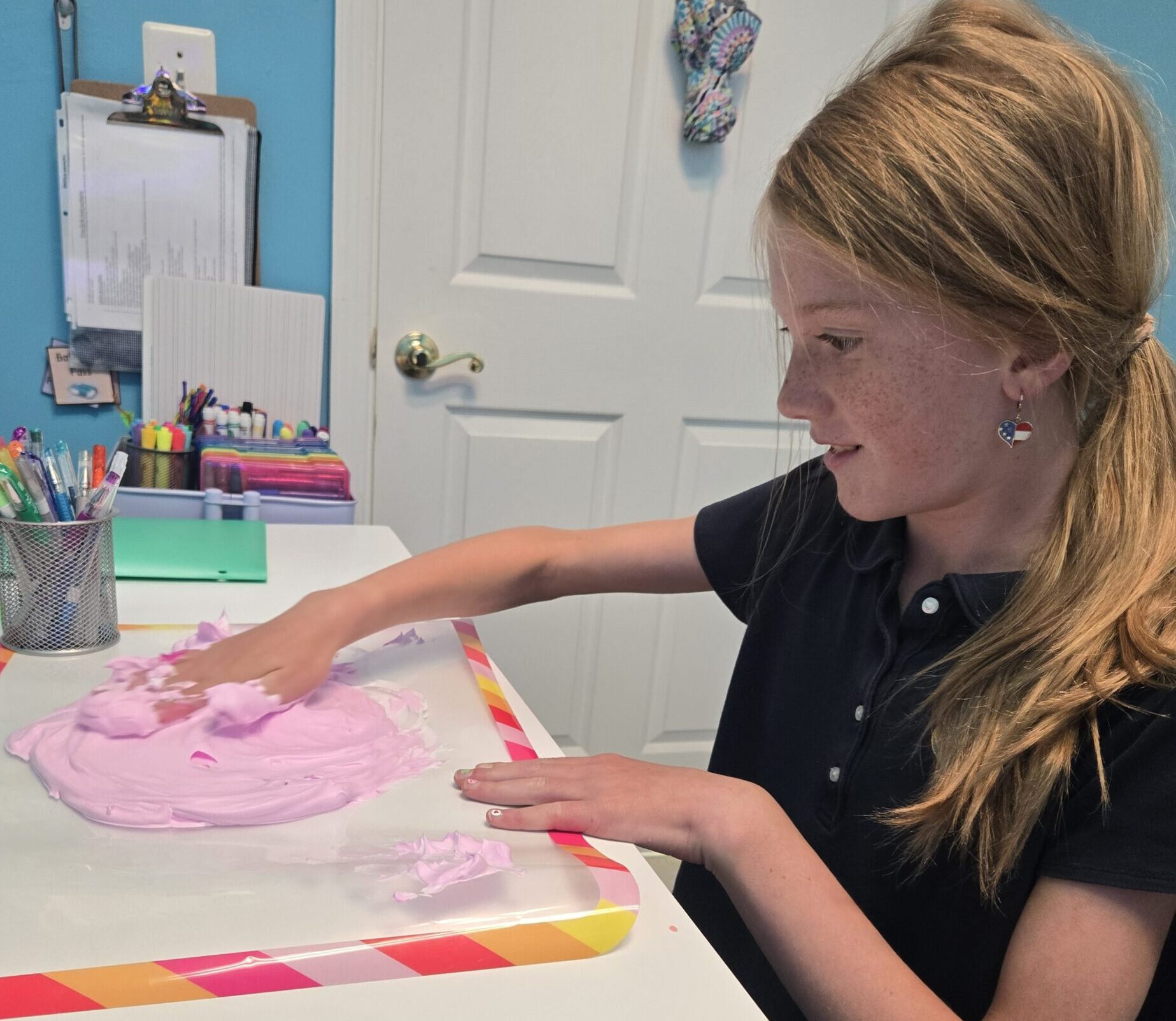 A student at The Legacy School uses a multi-sensory technique of writing using shaving foam.