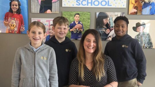 Founder and Head of School Jamie Caplan poses with 3 students at The Legacy School.